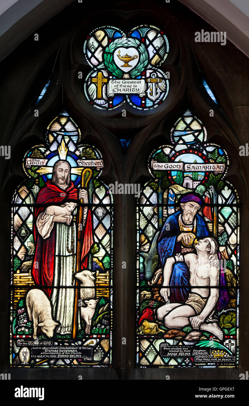 Good Shepherd and Good Samaritan stained glass in St. Peter`s Church, Bengeworth, Evesham, Worcestershire, England, UK Stock Photo